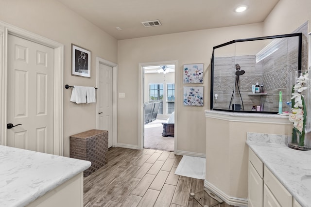 bathroom featuring vanity and a shower with shower door