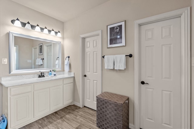 bathroom with vanity and wood-type flooring