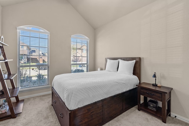 carpeted bedroom featuring lofted ceiling