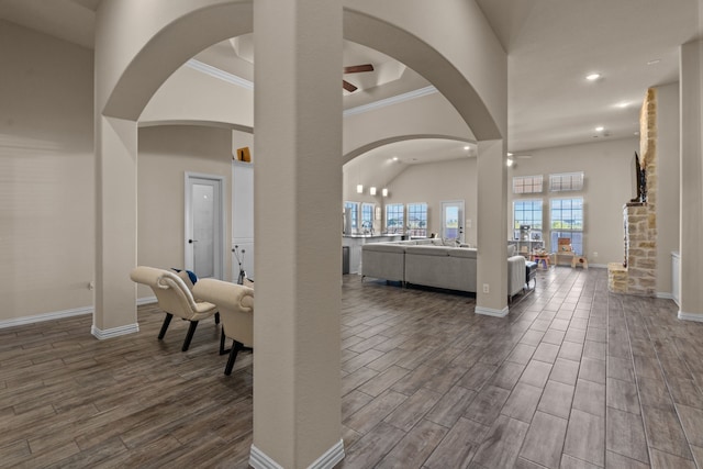 entrance foyer featuring crown molding, a towering ceiling, and ceiling fan