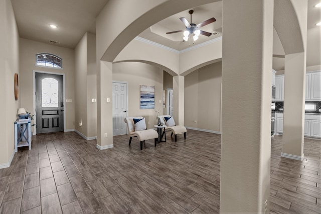 entryway with ceiling fan and a towering ceiling