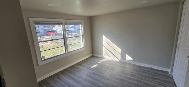 spare room featuring dark wood-type flooring