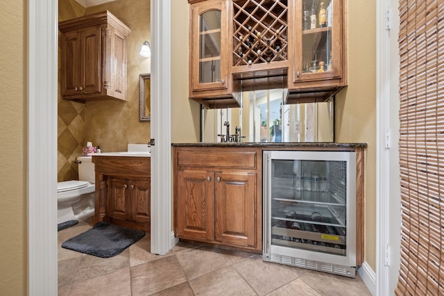 bar with light tile patterned floors and beverage cooler