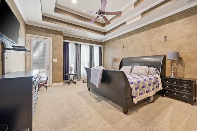 bedroom featuring crown molding, a tray ceiling, light colored carpet, and ceiling fan