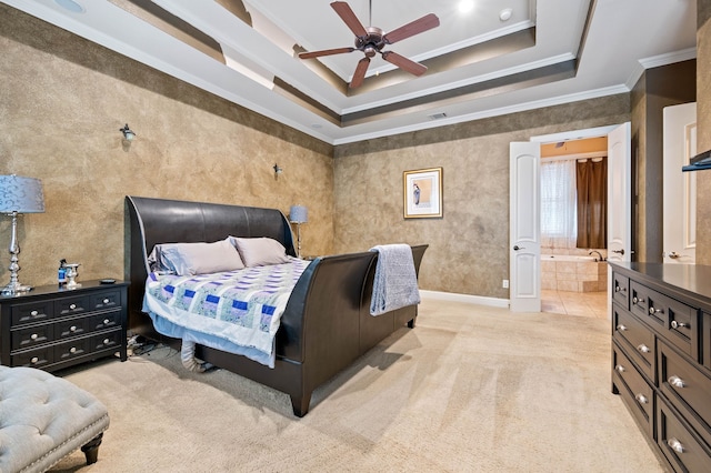 bedroom featuring ensuite bathroom, ornamental molding, light colored carpet, ceiling fan, and a raised ceiling