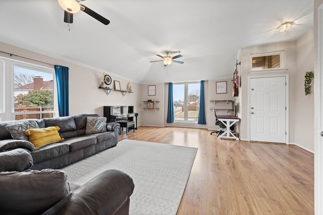 living room featuring vaulted ceiling, ceiling fan, ornamental molding, and light hardwood / wood-style floors