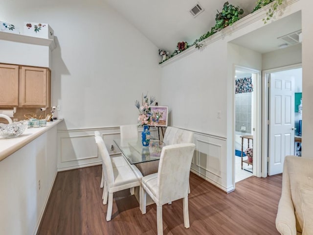 dining space featuring lofted ceiling and hardwood / wood-style floors