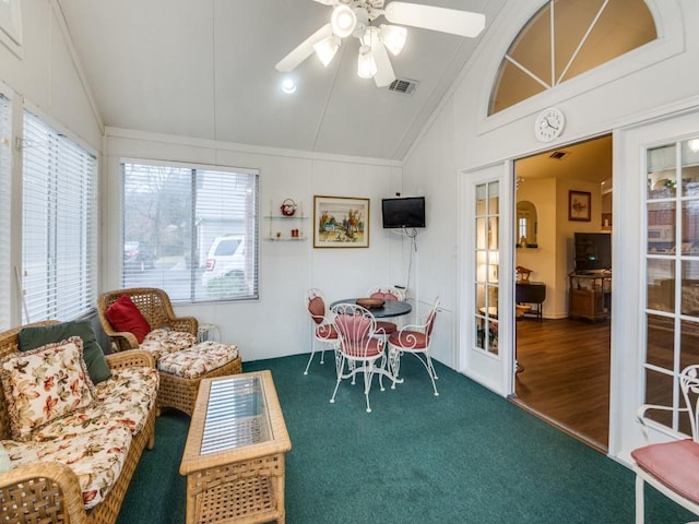 sunroom / solarium featuring ceiling fan, vaulted ceiling, and a healthy amount of sunlight