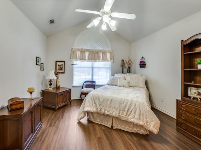 bedroom with ceiling fan, lofted ceiling, and dark hardwood / wood-style flooring