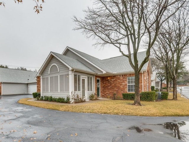 view of front of home with a garage and a front lawn