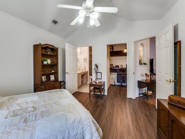 bedroom with vaulted ceiling, ensuite bathroom, dark hardwood / wood-style flooring, a walk in closet, and ceiling fan