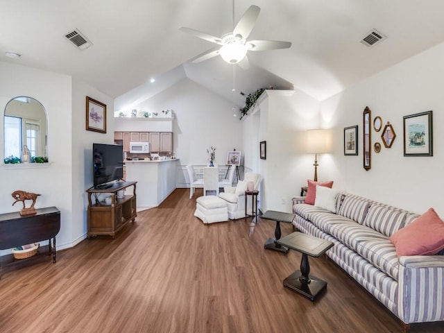 living room featuring lofted ceiling, light hardwood / wood-style flooring, and ceiling fan