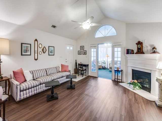 living room with ceiling fan, high vaulted ceiling, and dark hardwood / wood-style flooring