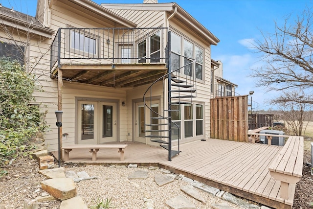 rear view of house featuring a wooden deck