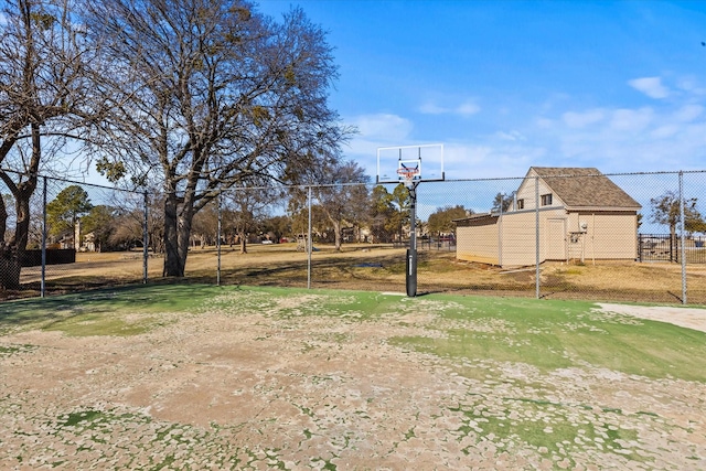 view of yard featuring basketball hoop