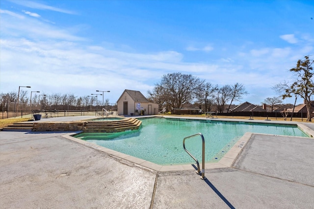 view of swimming pool featuring an in ground hot tub