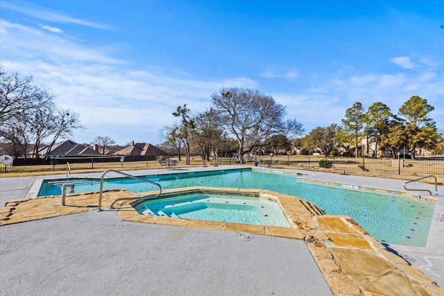 view of swimming pool featuring a community hot tub