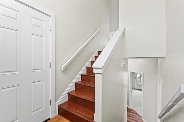 staircase with hardwood / wood-style floors