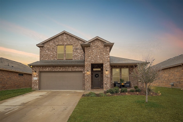 view of front of house featuring a garage and a lawn