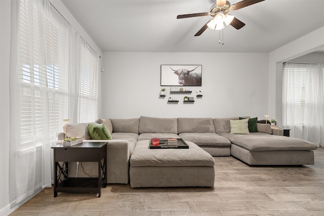 living room with ceiling fan and light hardwood / wood-style floors