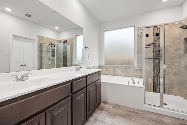 bathroom with vanity and independent shower and bath