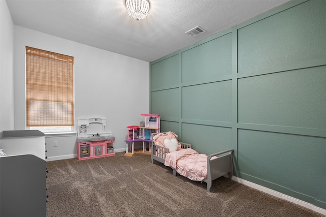 unfurnished bedroom featuring dark carpet and a textured ceiling