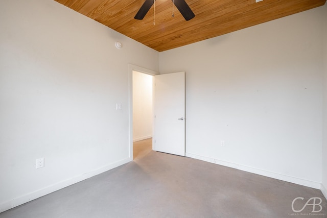 empty room featuring ceiling fan, concrete floors, and wood ceiling