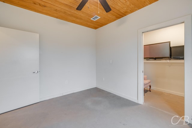 unfurnished room with wood ceiling, ceiling fan, and concrete floors