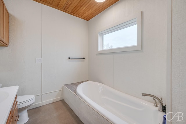 bathroom with toilet, wood ceiling, concrete floors, vanity, and a bath