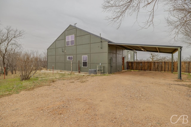 rear view of house with a carport and central AC