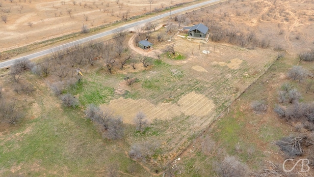 birds eye view of property with a rural view