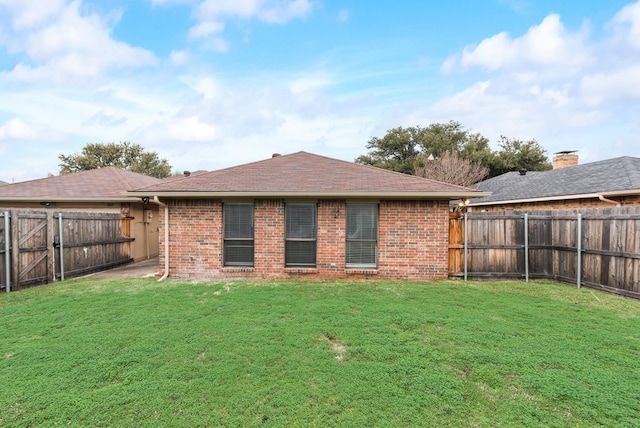 rear view of property featuring a yard