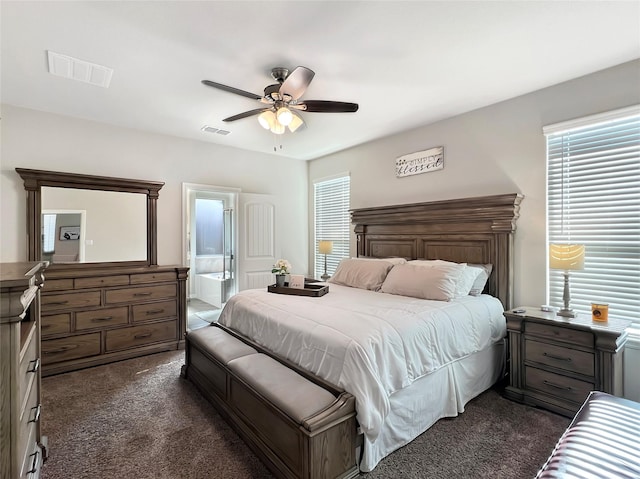 carpeted bedroom featuring ceiling fan and ensuite bath