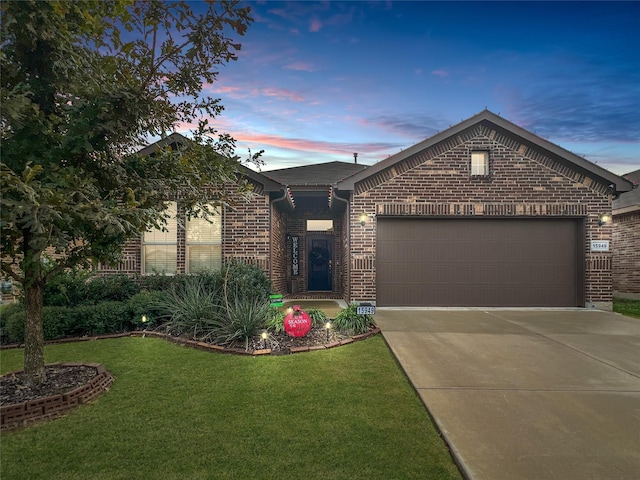 view of front of house with a garage and a lawn