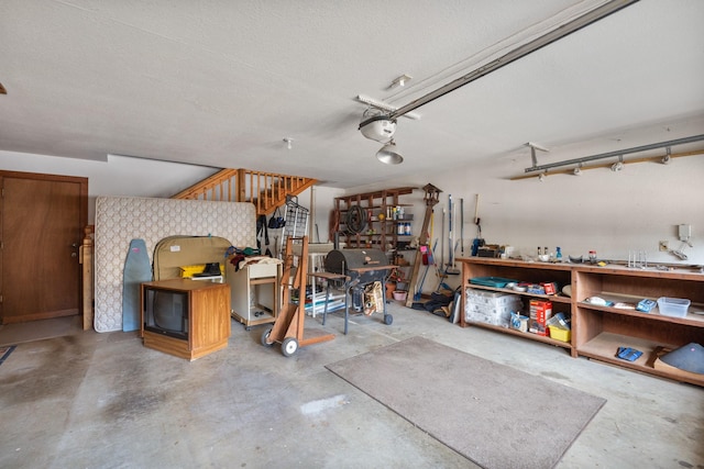 garage featuring a garage door opener and a workshop area