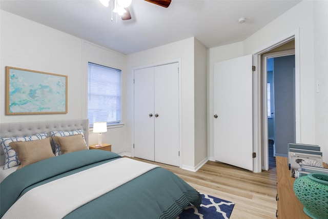 bedroom with ceiling fan, light hardwood / wood-style floors, and a closet