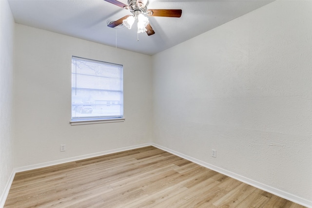 empty room with ceiling fan and light hardwood / wood-style floors