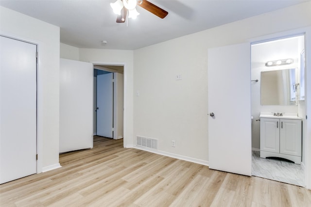 unfurnished bedroom with ceiling fan, connected bathroom, and light hardwood / wood-style flooring