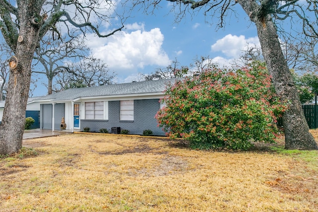 view of front of home with a garage and a front lawn