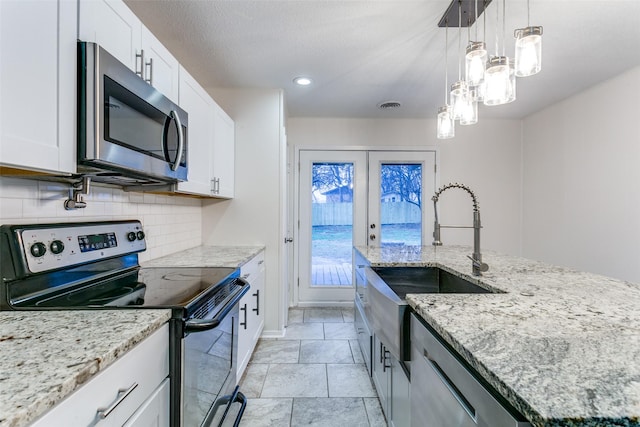 kitchen with stainless steel appliances, a kitchen island with sink, and white cabinets