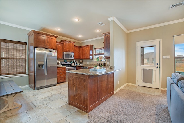 kitchen featuring stainless steel appliances, ornamental molding, dark stone countertops, and kitchen peninsula