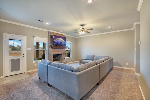 carpeted living room with crown molding, a brick fireplace, and ceiling fan