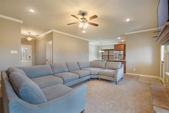 carpeted living room with crown molding and ceiling fan