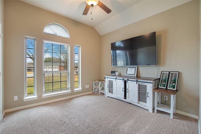 living room with ceiling fan, light colored carpet, and lofted ceiling