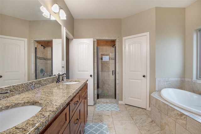 bathroom with vanity and independent shower and bath