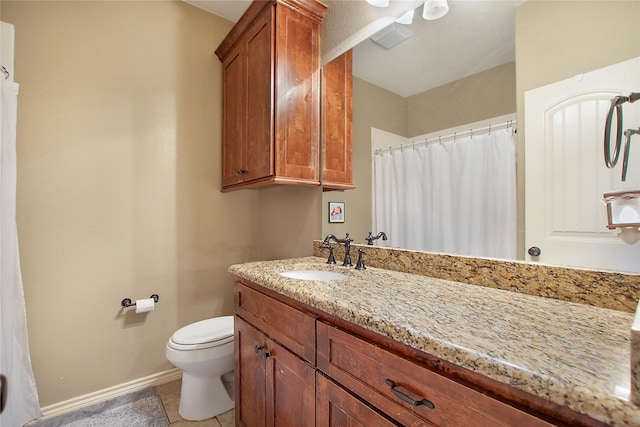 bathroom featuring vanity, tile patterned flooring, and toilet