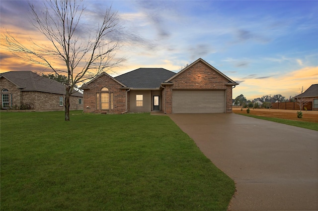 view of front of house with a garage and a lawn