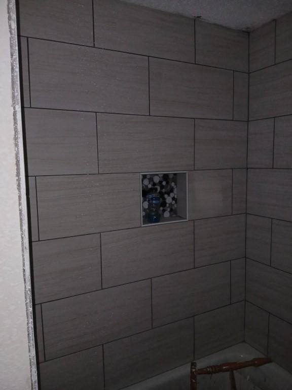 bathroom with tiled shower