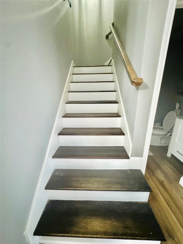 stairway featuring hardwood / wood-style flooring