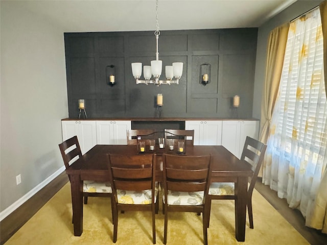 dining area with an inviting chandelier and light hardwood / wood-style floors